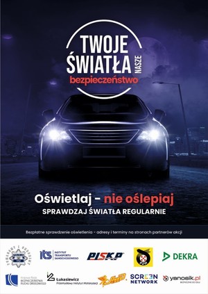 plakat w czarno granatowym odcieniu na którym widać samochód stojący przodem do obserwatora z włączonymi światłami w tle widać miasto na plakacie napis twoje światła nasze bezpieczeństwo oraz oświetlaj nie oślepiaj sprawdzaj regularnie światła